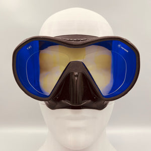 Diving mask with blue lenses on a mannequin head against a white background